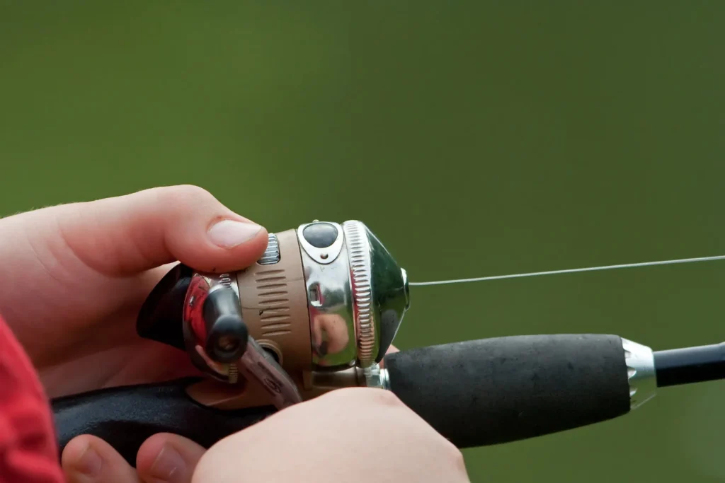 Close-up of a best spincast reel mounted on a rod handle
