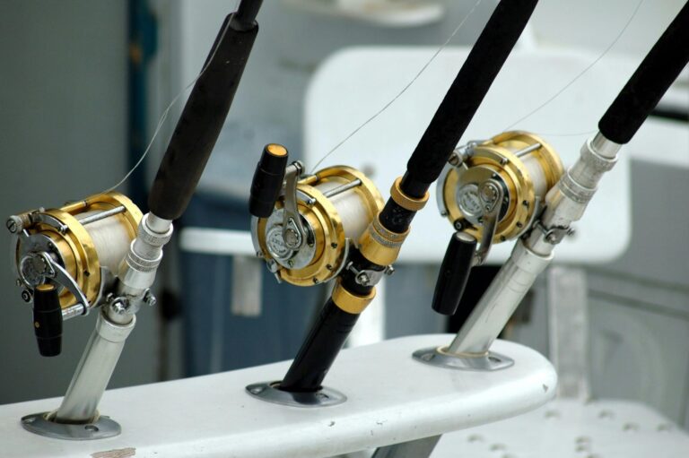 Three fishing rods with reels, demonstrating setups with no anti-reverse trigger