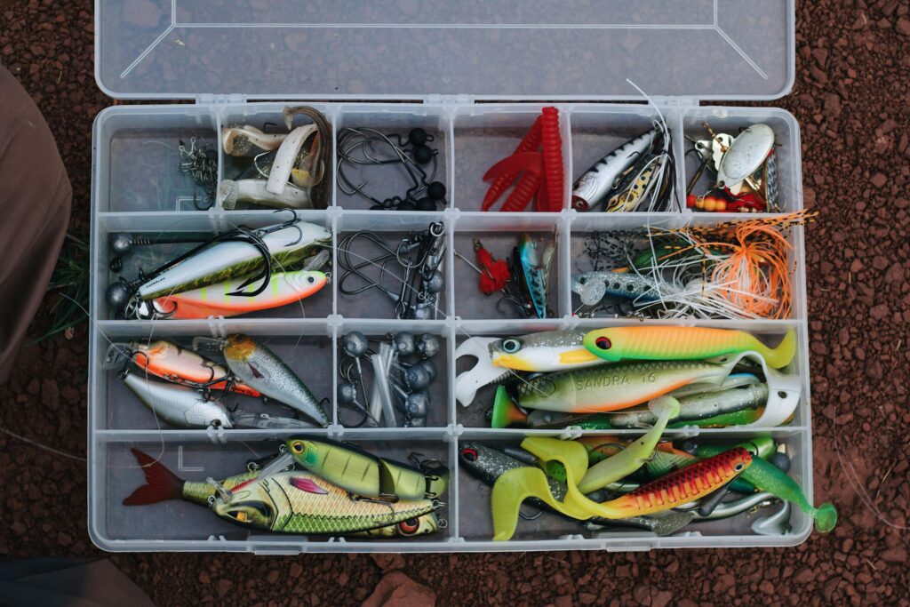 Box filled with the best bass fishing lures, neatly arranged by type and color for freshwater and bass anglers