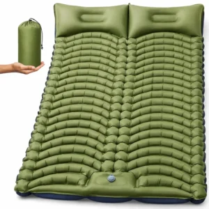 a double camping sleeping pad with two built-in pillows and wave-shaped air chambers, plus a storage bag shown in a hand